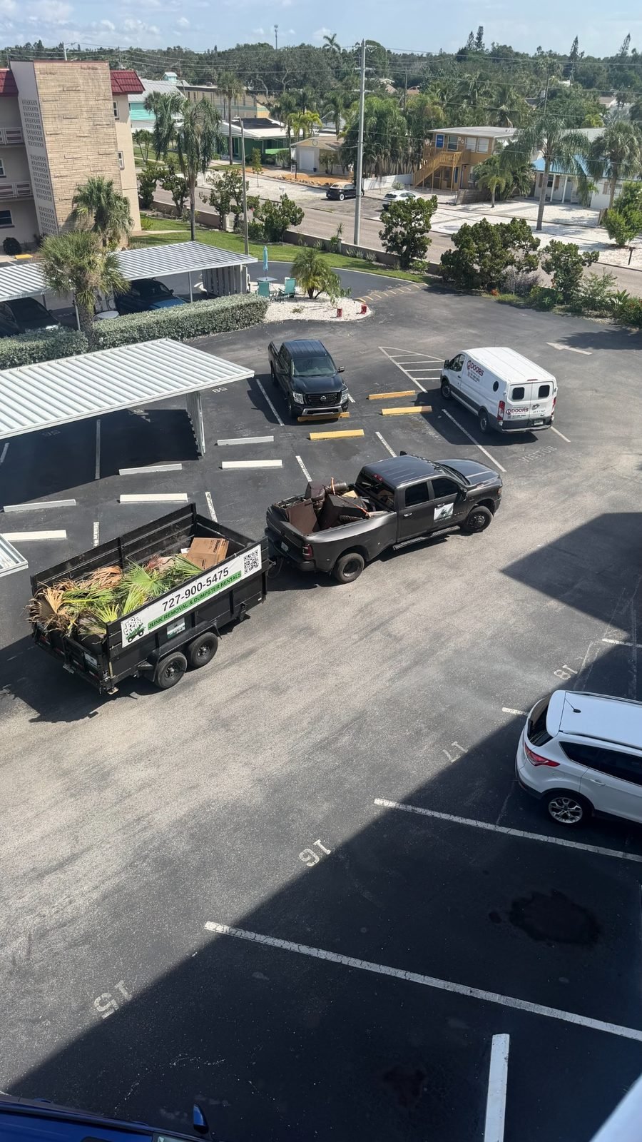 Branded No More Junk truck and loaded trailer during an apartment property cleanout in Clearwater, FL 33755