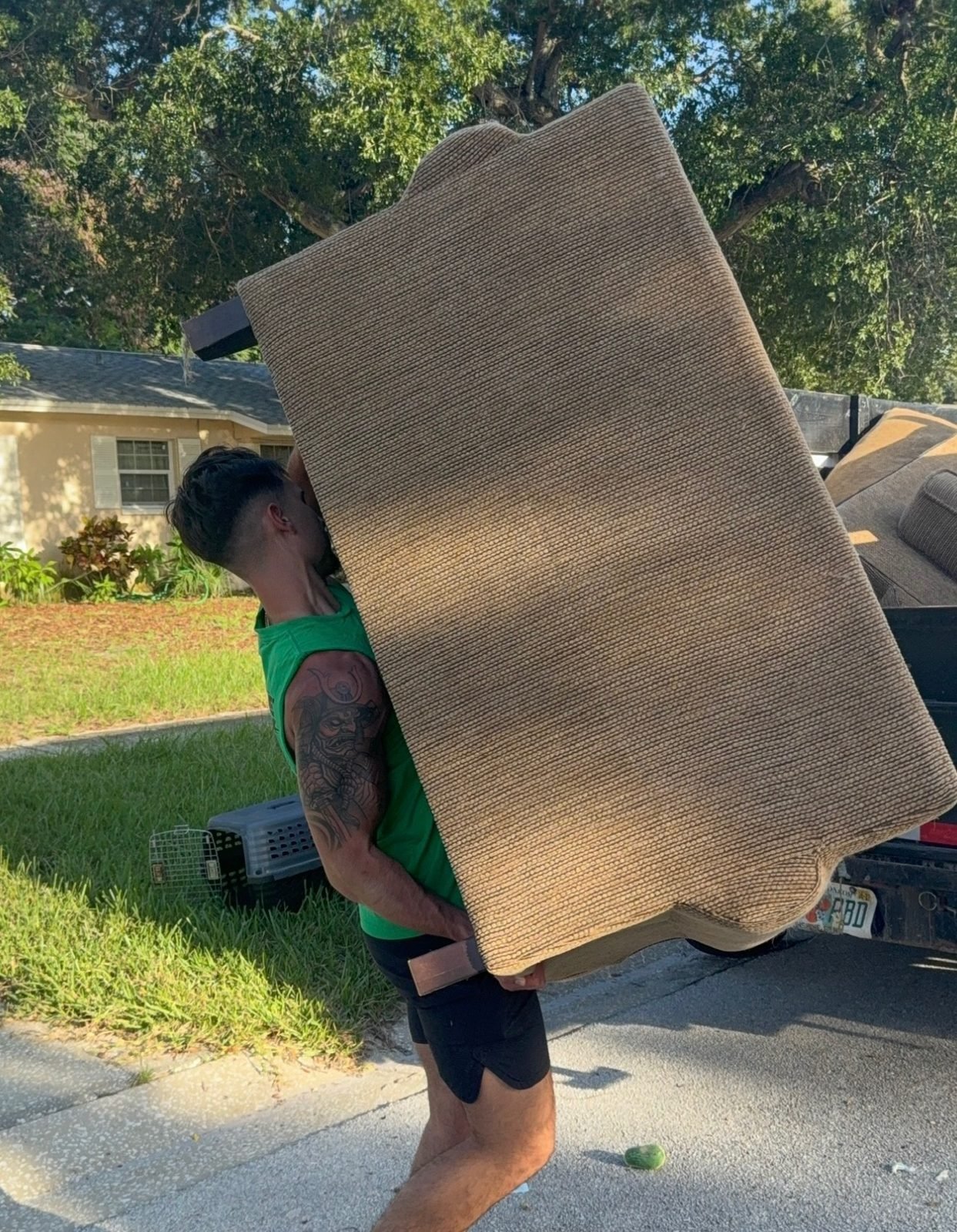 No More Junk crew removing a bulky upholstered chair during residential furniture hauling in Largo, FL 33770