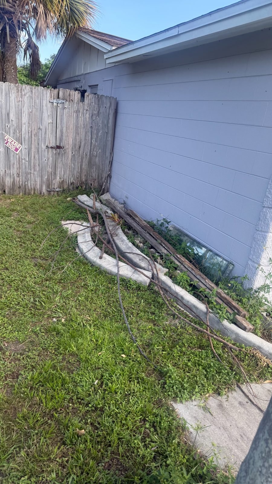 Before an estate side-yard cleanup with branches, blocks and outdoor debris in Safety Harbor, FL 34695
