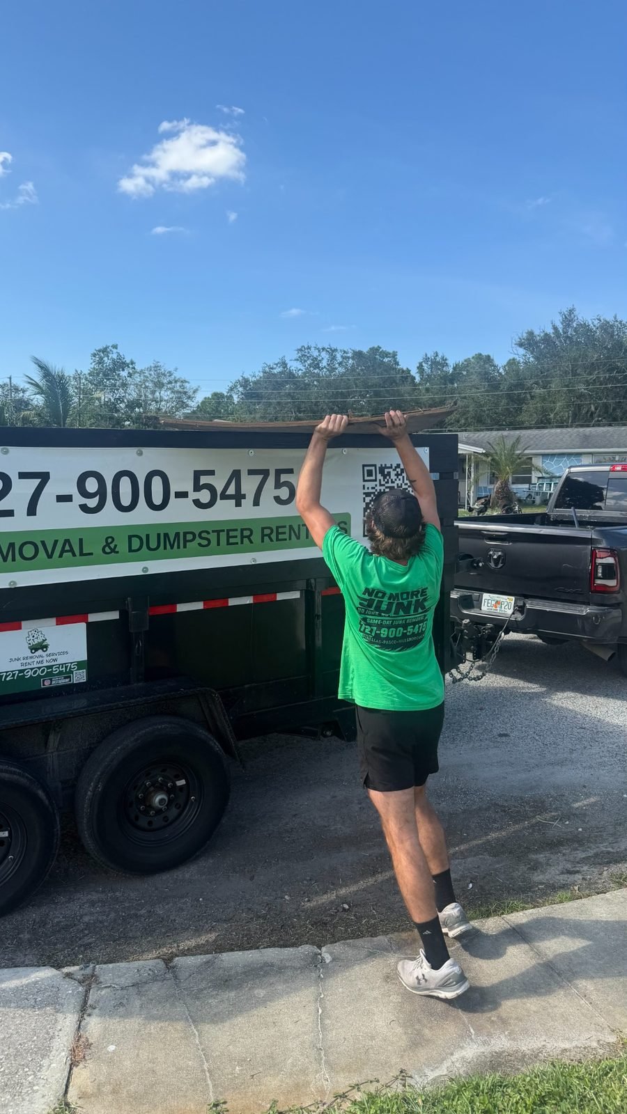 No More Junk crew loading long construction materials into a branded trailer in Tarpon Springs, FL 34688