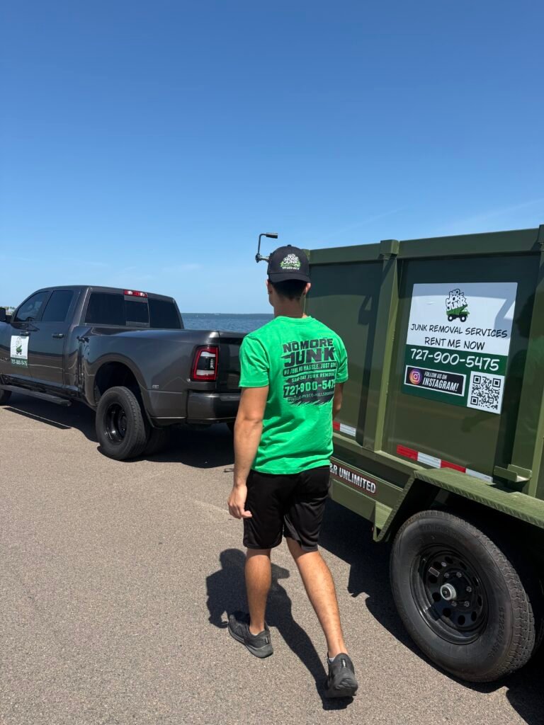 Palm Harbor junk removal crew member beside the No More Junk dump trailer
