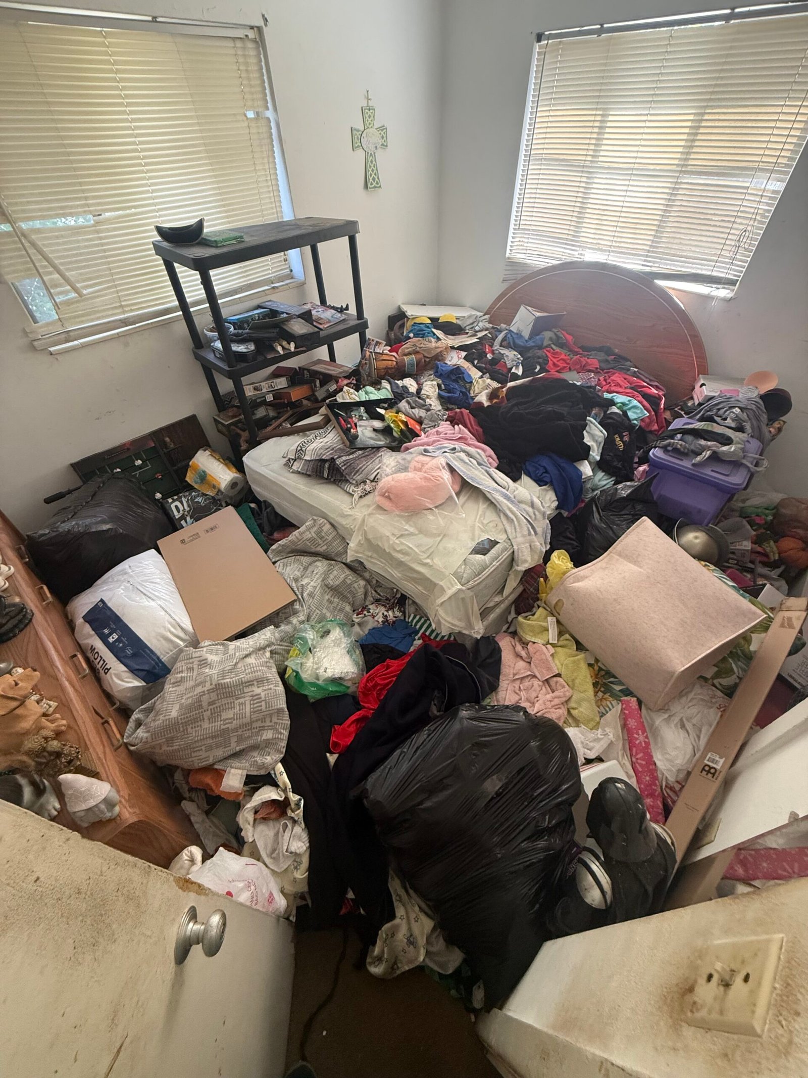 Extreme hoarder house cleanout with junk removal crew clearing cluttered living room in St. Petersburg FL.