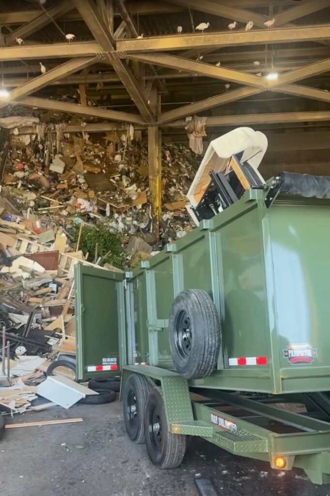 Junk removal trailer unloading debris at a recycling and disposal facility in Pinellas County, Florida.