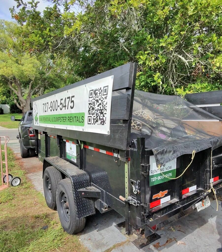 No More Junk dump trailer fully loaded with junk and debris after a property cleanout in Palm Harbor, FL.