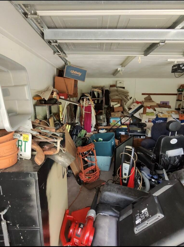Garage cleanout in progress by No More Junk in Palm Harbor, FL, removing unwanted furniture, household items, electronics, and clutter.
