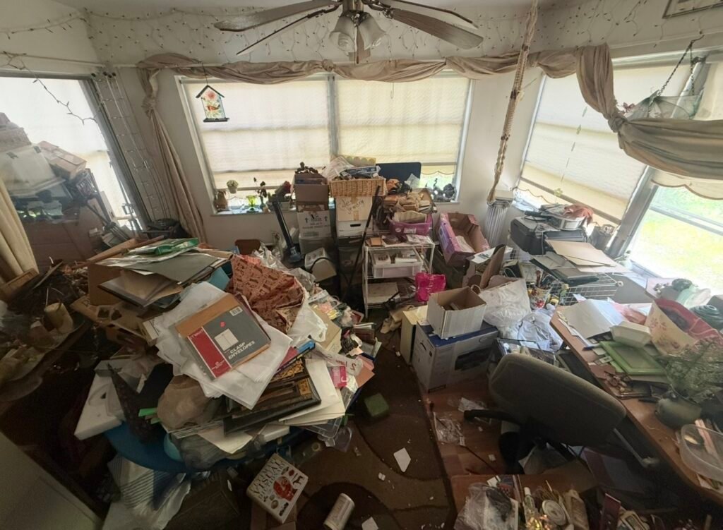 Interior of a hoarder home before professional cleanout by No More Junk in Clearwater, FL, showing heavy household clutter and accumulated belongings.
